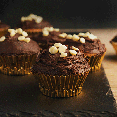 chocolate cupcakes with white chocolate chips on top